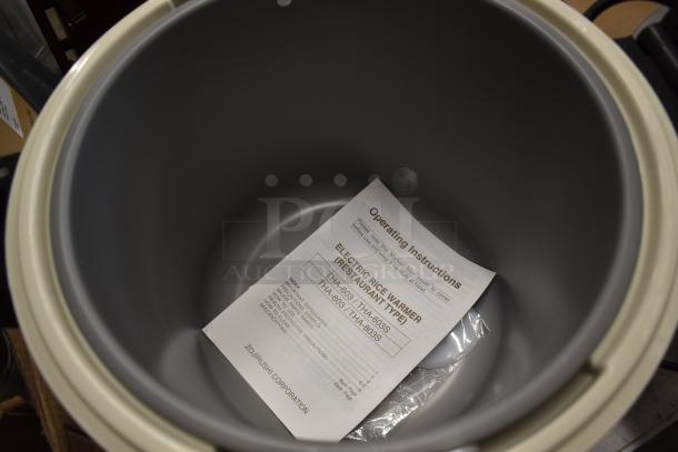 Zojirushi electric rice warmer interior with operating instructions and product label indicating model THA-603/603S.