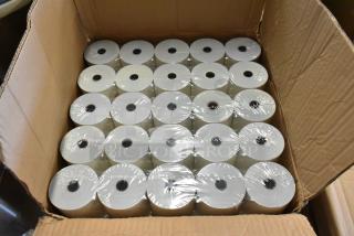 Box of thermal paper rolls, neatly stacked. Each roll is shrink-wrapped. Ideal for receipt printers, excellent condition.