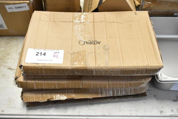 Stack of three damaged cardboard boxes sealed with tape, label reads "214 QTY x3," suggesting a lot of three items from PCI Auctions.