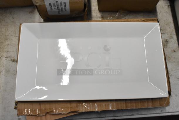 White rectangular ceramic serving platter, pristine condition, placed on cardboard box, ideal for elegant dining displays.