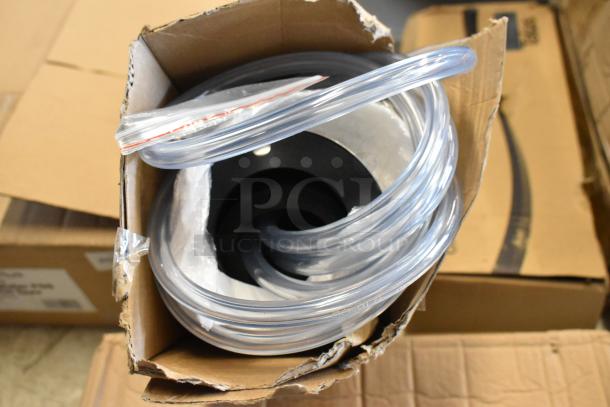 Coiled clear tubing in an opened cardboard box, new condition. Suitable for plumbing or industrial use.