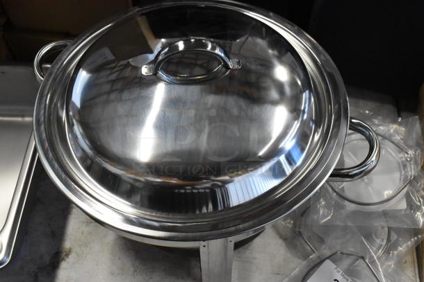 Stainless steel chafing dish with lid, dual handles, and sturdy base, in excellent condition. Ideal for buffets or catering.