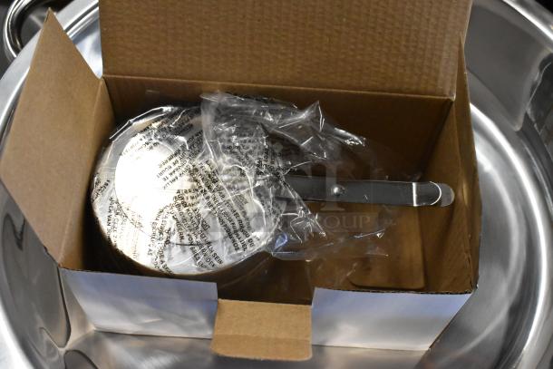 Stainless steel kitchen utensil, new in cardboard box, wrapped in plastic with printed instructions visible.