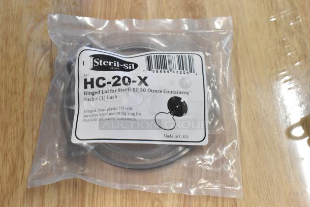 Steril-Sil HC-20-X hinged lid for 30 oz containers, clear plastic, stainless steel ring, new in sealed packaging, Made in USA.