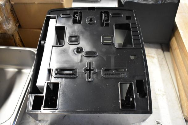 Black plastic appliance base tray in good condition, featuring multiple slots and openings for components.
