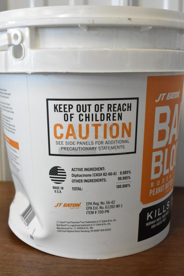 JT Eaton Bait Block rodenticide bucket. Contains Diphacinone. Caution label warning. Made in USA. EPA registered.