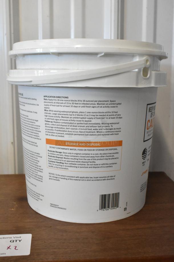 White plastic bucket of rodenticide with detailed instructions and storage warnings on the label.