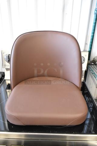 Brown leather seat cushion with curved backrest in excellent condition. Simple, modern design suitable for various settings.