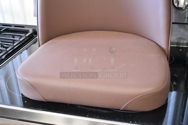 Brown vinyl seat cushion with backrest, smooth finish, no visible damage, ideal for kitchen or dining chairs.
