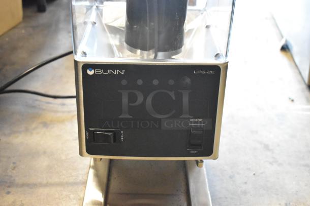 Bunn LPG-2E coffee grinder, black with clear top, featuring left/right control and off/stop switch, in good condition.