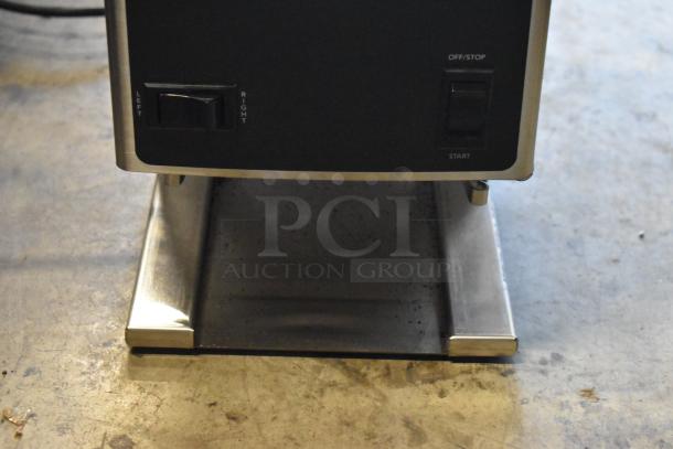 Industrial machine base with control panel, featuring left/right and start/off switches. Sturdy metal construction.