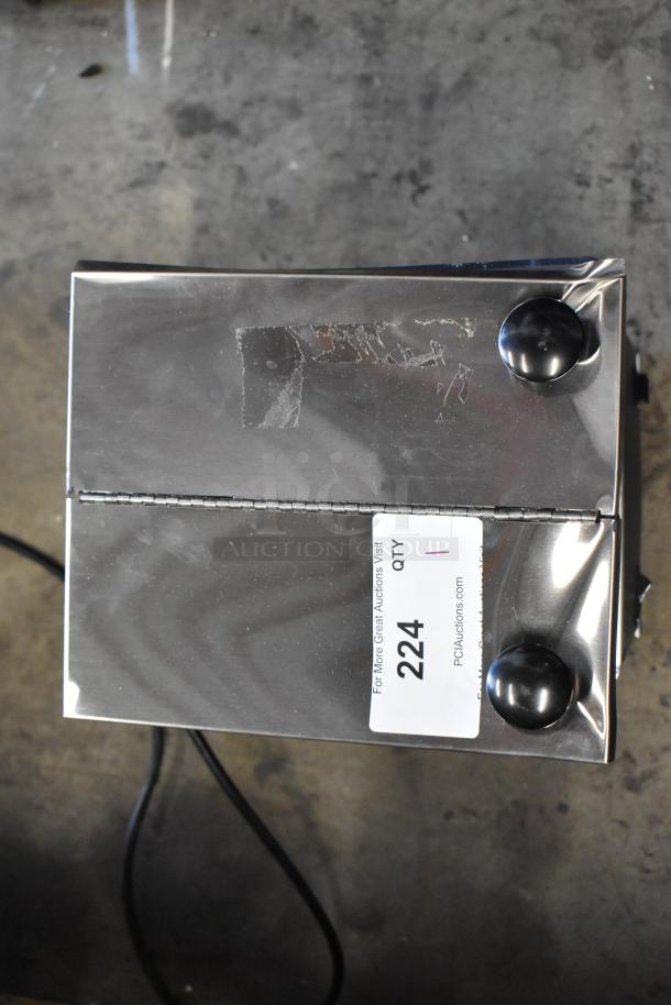 Chrome toaster with two slots, black knobs, and auction tag marked "224." Appears in good condition.