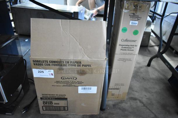 Cardboard boxes for auction, one labeled "Dart" for paper cone cups, quantity 225; another for "Cutlerease" plastic knife dispenser.