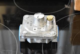 Gas pressure regulator RV48, 1/2 PSIG, metal finish, brand label visible, used condition, ideal for appliance installation.