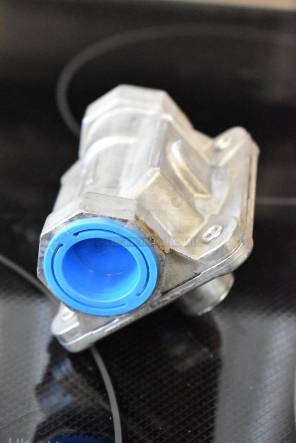 Metal automotive valve with blue cap, silver housing, and visible screw mounts. Appears in good condition.