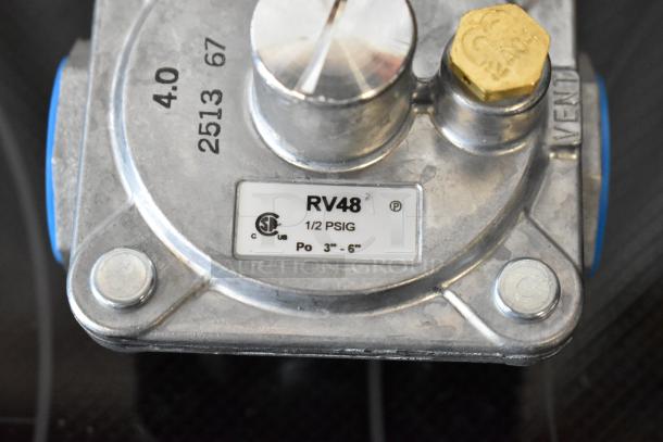 Gas regulator RV48, 1/2 PSIG, marked "2513 67", with CSA certification, features brass adjustment knob, in good condition.