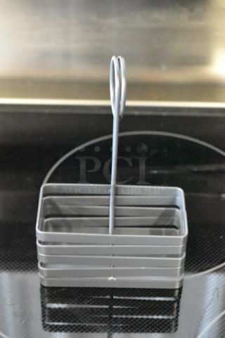 Gray metal napkin holder with a vertical loop handle, modern design, excellent condition.