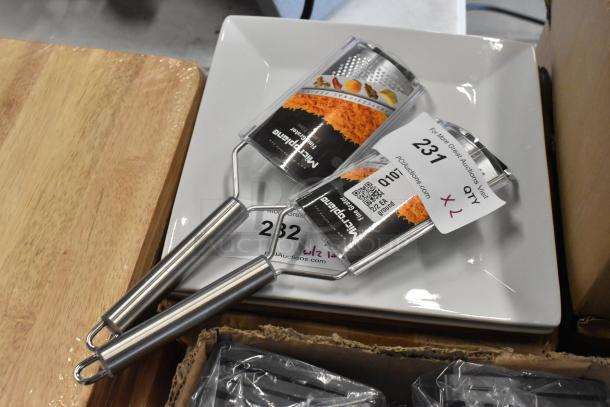 Two Microplane graters with stainless steel handles, new condition, labeled with auction tags indicating lot 231, quantity 2.