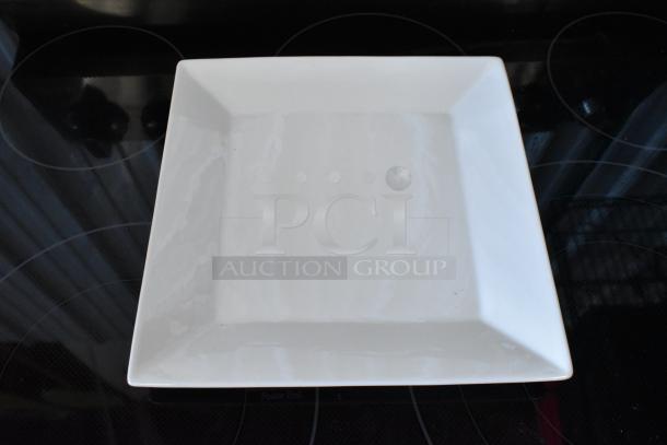 Square white ceramic serving plate, glossy finish, excellent condition, no visible markings or chips.