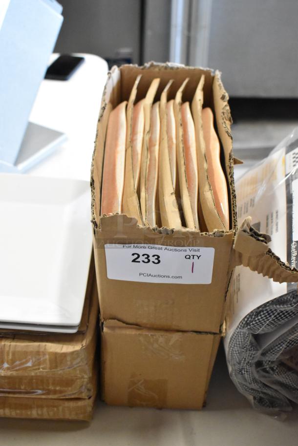 Box of tan file folders with visible auction tag marked "233, QTY 1" from PCIAuctions.com. Folders appear intact.