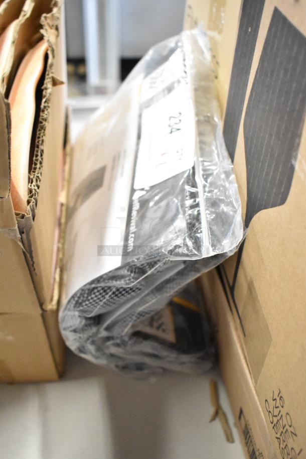Sealed cardboard box with a clear plastic-wrapped item inside, featuring a visible label with "234." Condition appears new.