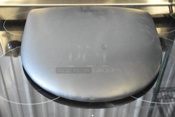 Black leather cushioned seat on a circular base, in good condition, no visible markings or labels.