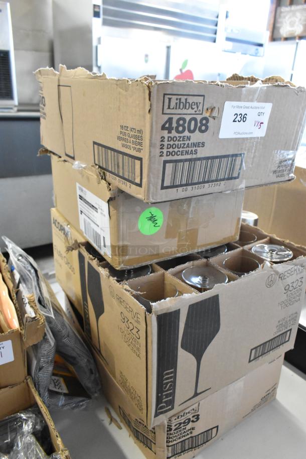 Boxes of Libbey glassware. Top box marked "Libbey 4808," contains two dozen 16 oz pub glasses. Signs of wear on boxes.