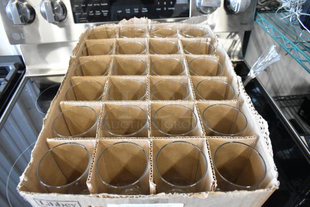 Box of 24 Libbey glass tumblers in new condition, neatly arranged in cardboard dividers. Suitable for drinks, durable glassware.