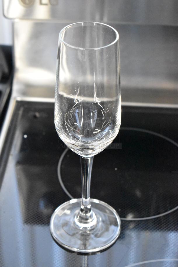 Clear crystal champagne flute, elegant design, in excellent condition, no visible markings or labels.