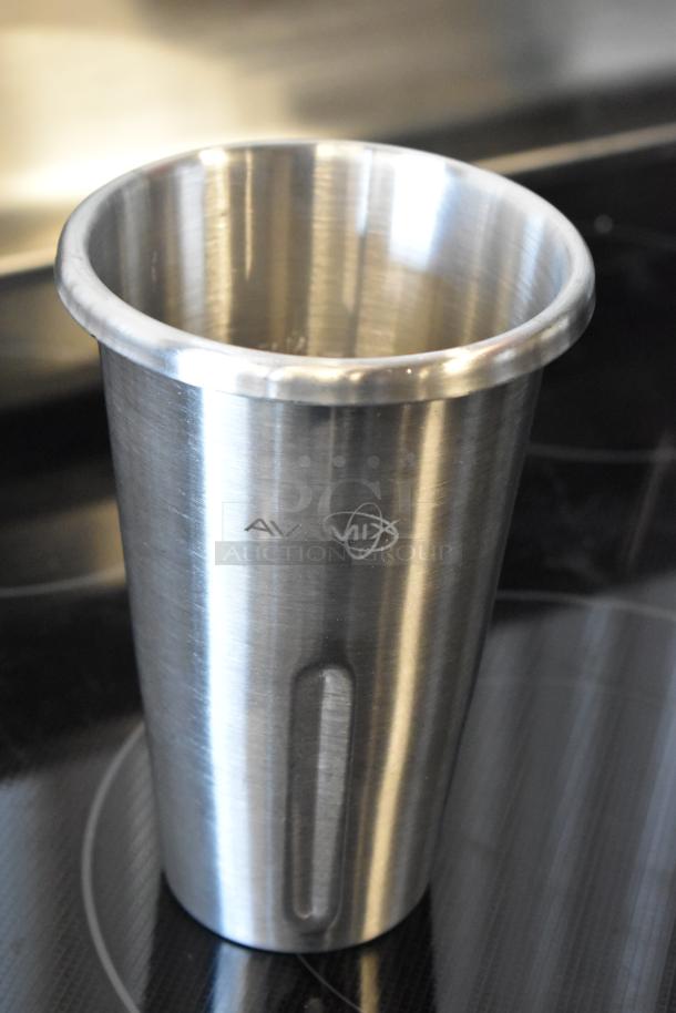 Stainless steel Avamix milkshake cup, lightly used, branded logo on side, suitable for commercial blenders.