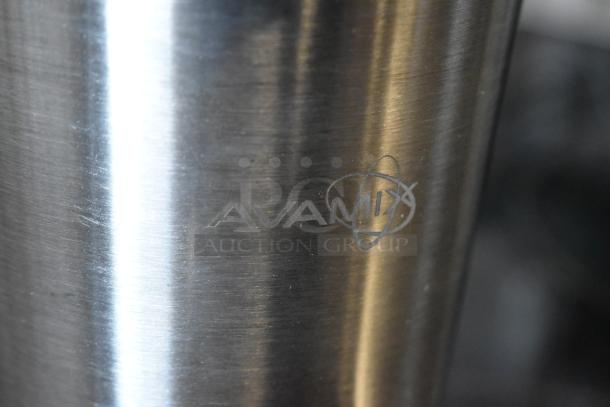 Avamix stainless steel blender jar, logo etched on surface, polished finish, appears in excellent condition.