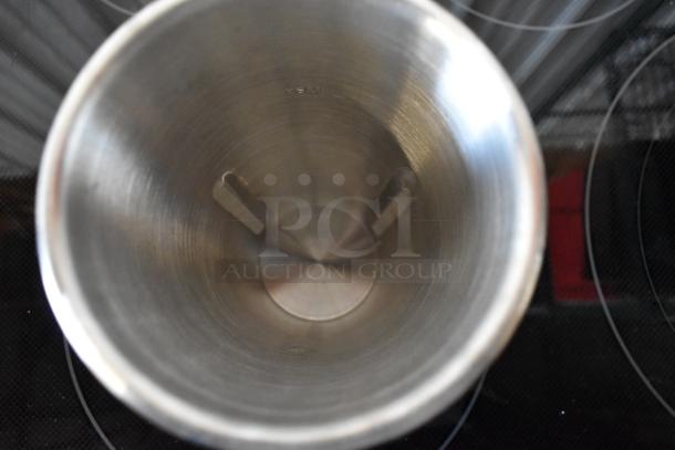 Stainless steel cylindrical vessel, visible X-M marking, shows interior detailing, in good condition.