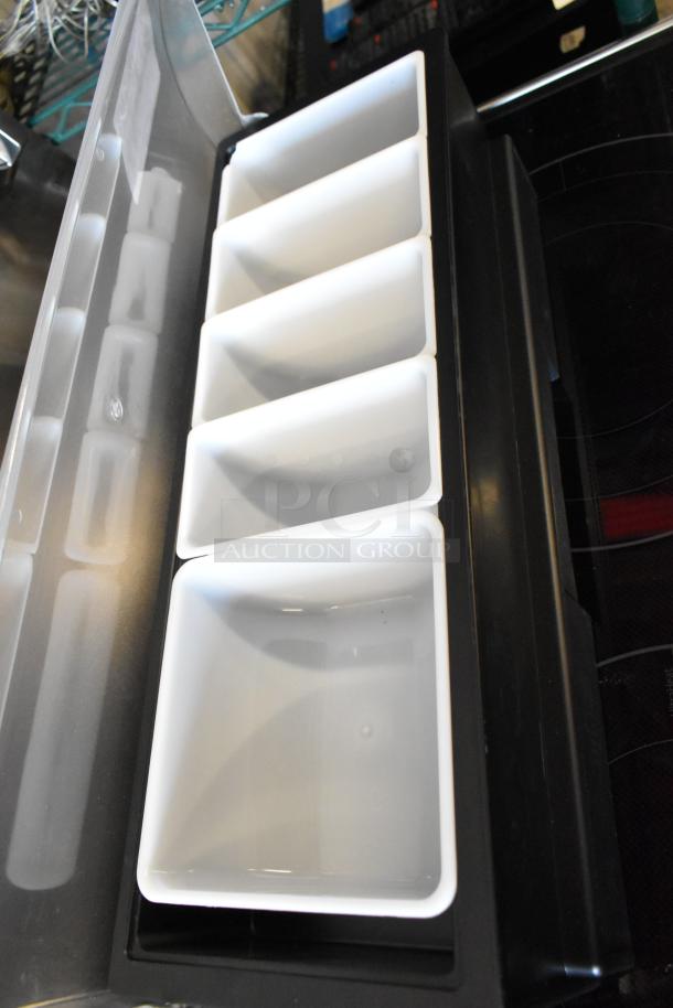 Black condiment holder with five white removable bins, excellent condition, ideal for organizing kitchen or bar supplies.
