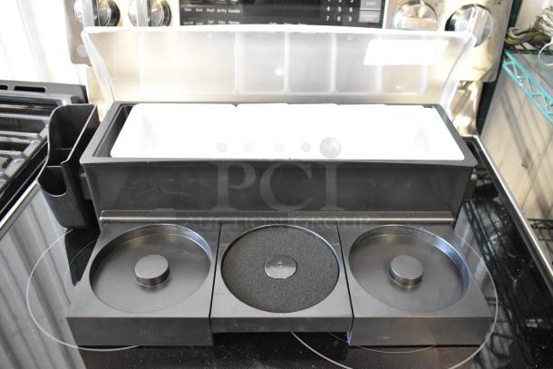 Black bar station set with three compartments and a clear lid, ideal for cocktail preparation, in excellent condition.