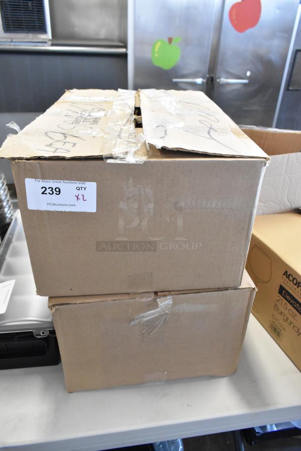 Two cardboard boxes taped shut, one with an auction label reading "239 QTY XL." Boxes appear in good condition.