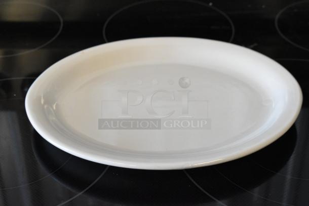 White ceramic dinner plate, round, smooth finish, appears in excellent condition, no visible markings or tags.