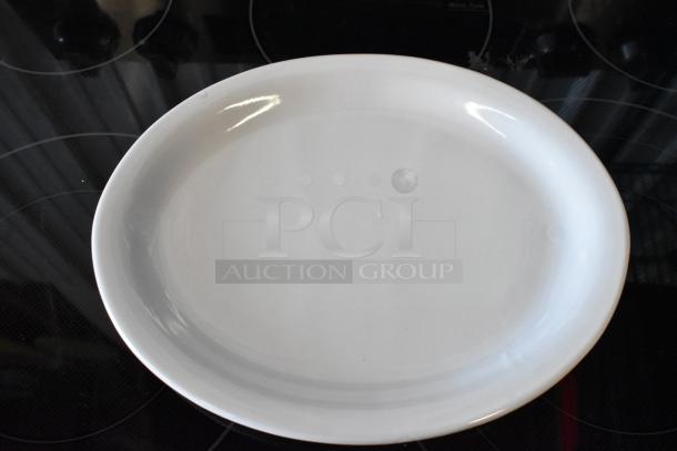 Large white ceramic oval platter, minimalistic design, excellent condition, reflective surface, no visible markings or labels.