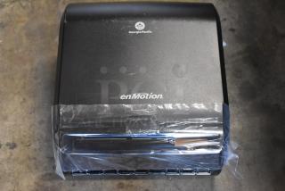 Georgia-Pacific enMotion automatic paper towel dispenser, black, new condition, protective plastic wrap intact.