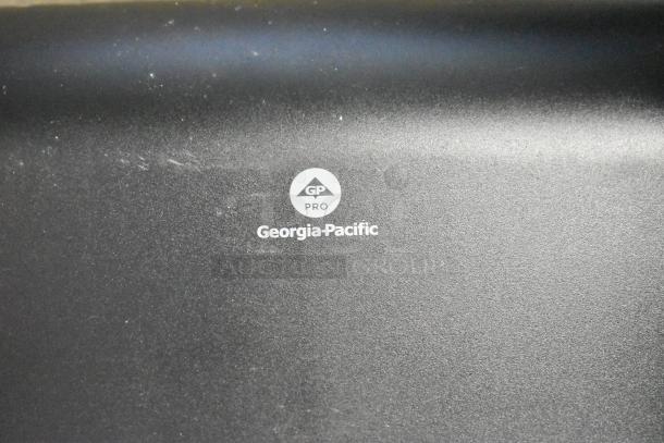 Georgia-Pacific Pro black surface with logo. Slight wear visible. Suitable for professional use.