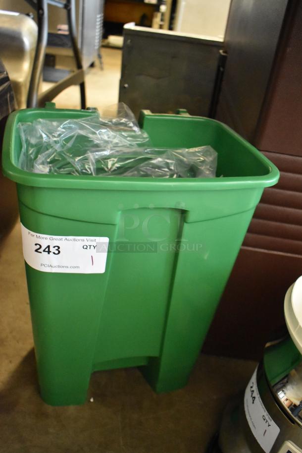Green plastic bin with attached label "243 QTY 1" from PCI Auctions, filled with clear plastic bags. Appears in good condition.
