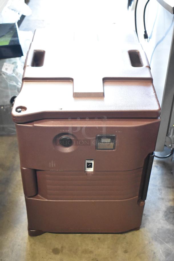 Brown insulated food pan carrier, rugged design, handles and latch visible, suitable for catering. Good condition.