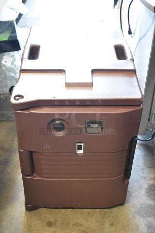 Brown insulated food pan carrier, rugged design, handles and latch visible, suitable for catering. Good condition.