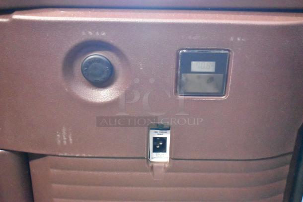 Vintage brown arcade machine control panel with a digital display showing "70.8," a black knob, and a "100-120VAC ONLY" power socket. Good condition.