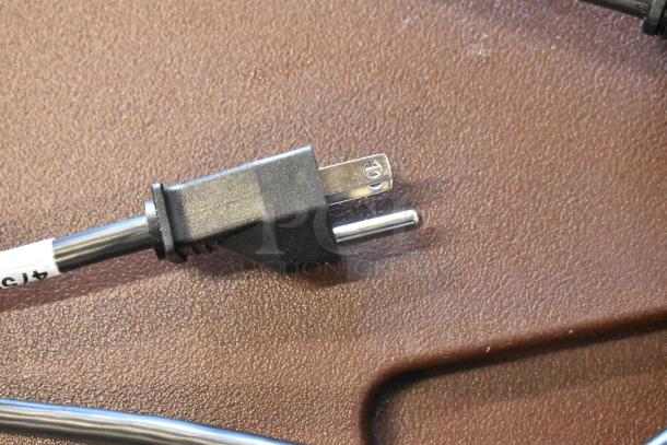 Black electrical plug with two prongs and attached thick cord. Visible label reads "415". Good condition.