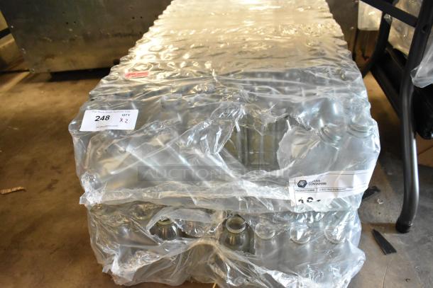 Pallet of stacked glass bottles wrapped in plastic. Label shows "247 QTY x 2" and "Product Code: JGCSG-16oz. Brand: Aptiva Containers."
