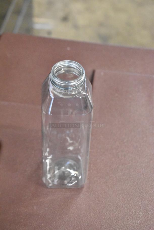 Clear square glass bottle, empty, excellent condition, no labels or markings, wide mouth, suitable for storage or display.