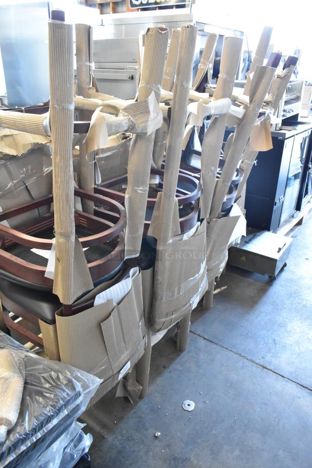 Stacked wooden chairs wrapped in cardboard for protection, indicating new or unused condition, ready for shipping or storage.