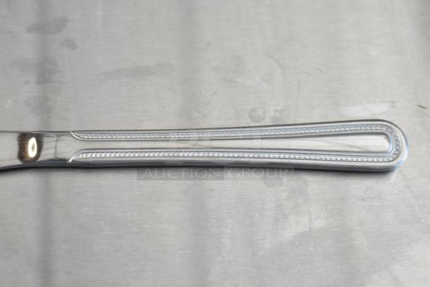 Polished silverware handle with beaded edge design, excellent condition, no visible markings or wear.