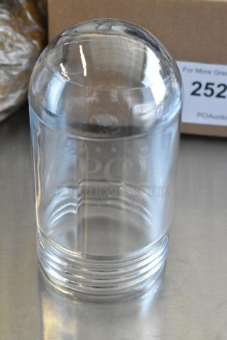 Clear glass dome paperweight with a smooth, rounded top and ribbed base, in excellent condition.