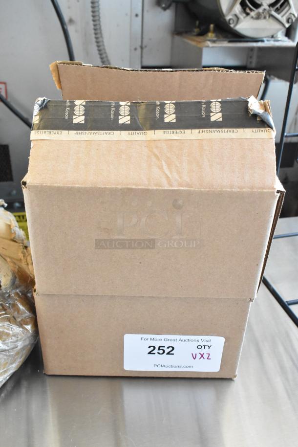 Sealed cardboard box with "Crafstmanship, Quality, Expertise" tape, labeled "252 QTY VXZ," from PCI Auctions.